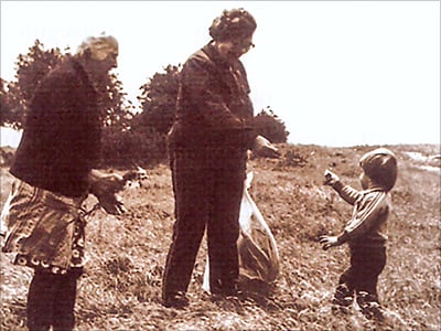 Young Aunt Ilike gathering herbs with village herbalist grandmother